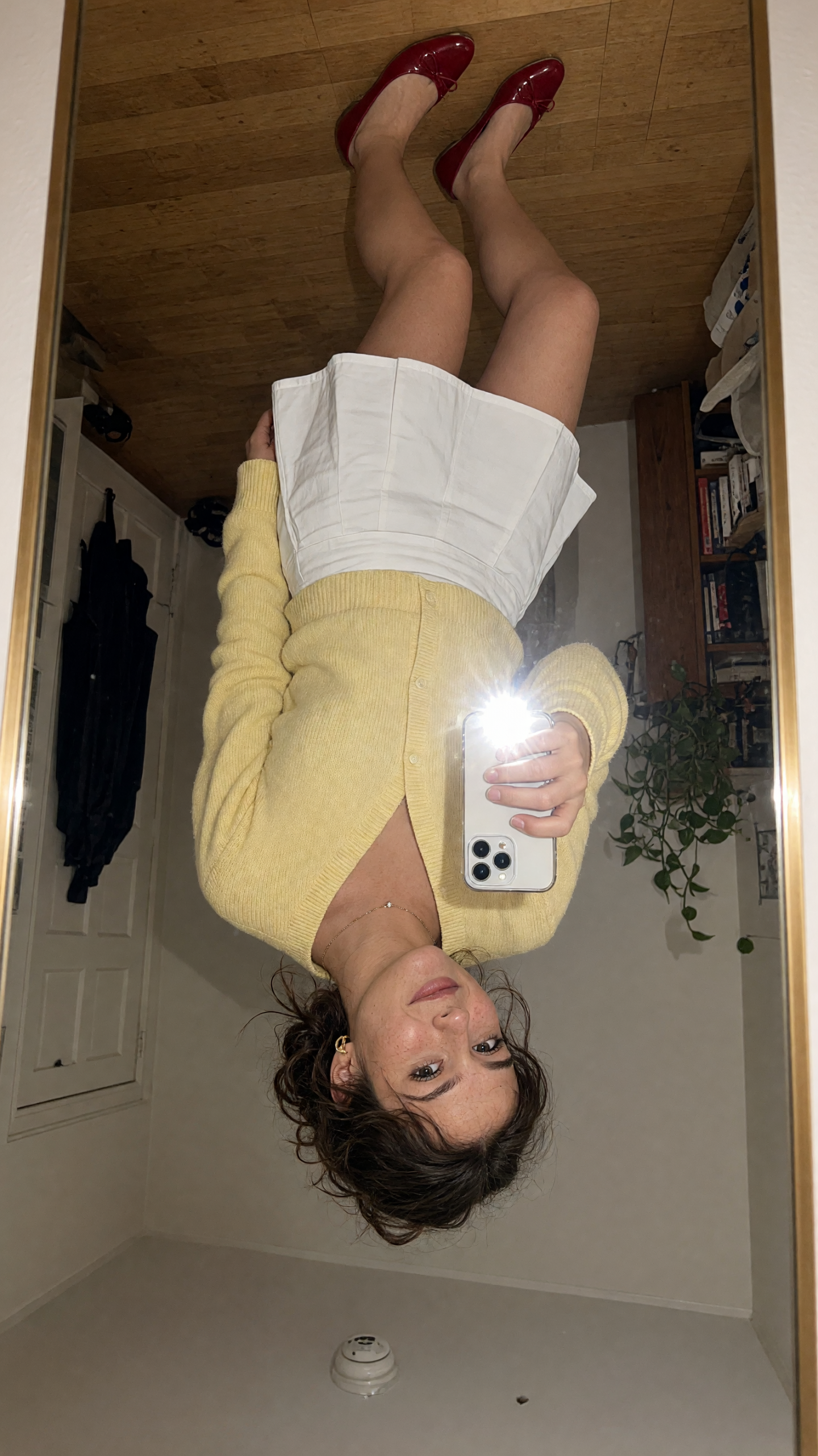 Inverted camera effect with yellow cardigan and white skirt